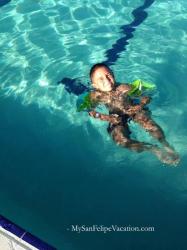 Young boy swimming at the El Cachanilla Pool in El Dorado Ranch, San Felipe